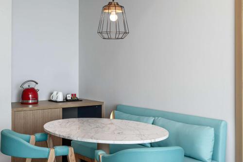 a dining room with a table and two chairs at Hampton by Hilton Marjan Island in Ras al Khaimah