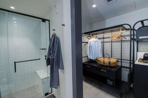a walkin closet with a glass shower stall and a purse at Canopy By Hilton Jersey City Arts District in Jersey City
