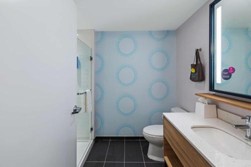 a bathroom with a toilet and a sink and a shower at Tru By Hilton Laredo Airport Area, Tx in Laredo