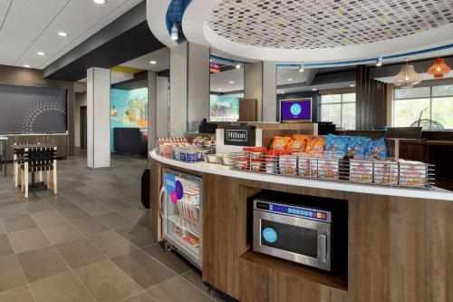 a fast food restaurant with a counter with food at Tru By Hilton Sandusky, Oh in Sandusky