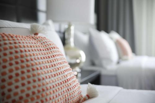 a close up of a pillow on a couch at The Rewind West Des Moines, Tapestry Collection By Hilton in West Des Moines