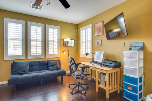 a living room with a couch and a desk with a computer at Serene Las Vegas Home with Heated Pool Near Strip! in Las Vegas