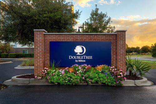 a sign for a do not enter sign with flowers at DoubleTree by Hilton Charleston Mount Pleasant in Charleston