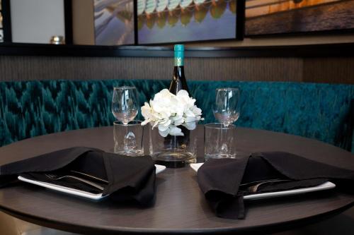 a table with a bottle of wine and a flower on it at DoubleTree by Hilton Charleston Mount Pleasant in Charleston