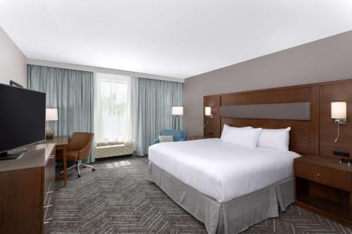 a hotel room with a bed and a flat screen tv at DoubleTree by Hilton Charleston Mount Pleasant in Charleston