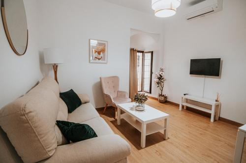 ein Wohnzimmer mit einem Sofa und einem Tisch in der Unterkunft Apartamentos Turaca in Trujillo