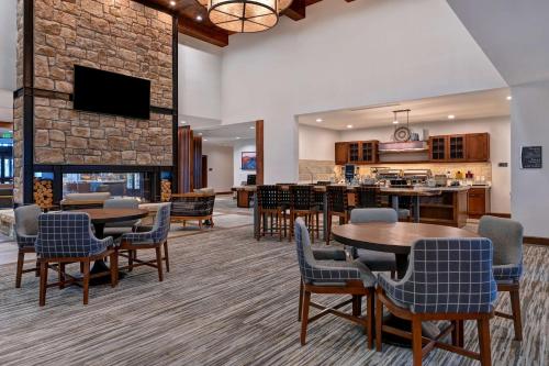 a lobby with tables and chairs and a fireplace at Homewood Suites By Hilton Eagle Boise, Id in Eagle