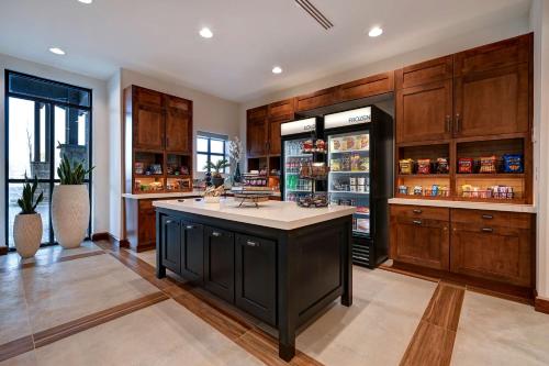 a large kitchen with wooden cabinets and a large island at Homewood Suites By Hilton Eagle Boise, Id in Eagle
