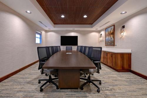 a conference room with a table and chairs and a tv at Homewood Suites By Hilton Eagle Boise, Id in Eagle