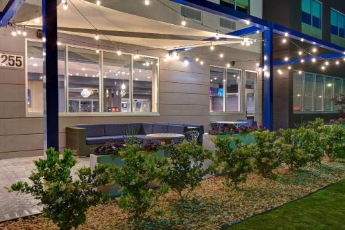 a building with a patio with lights and plants at Tru By Hilton Rocky Mount, Nc in Rocky Mount
