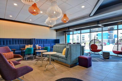 a waiting room with colorful chairs and tables and windows at Tru By Hilton Rocky Mount, Nc in Rocky Mount