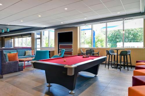 a billiard room with a pool table and chairs at Tru By Hilton Rocky Mount, Nc in Rocky Mount