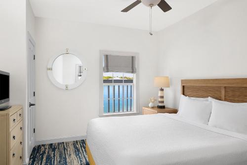 a white bedroom with a bed and a window at Hyatt Vacation Club at Beach House in Key West