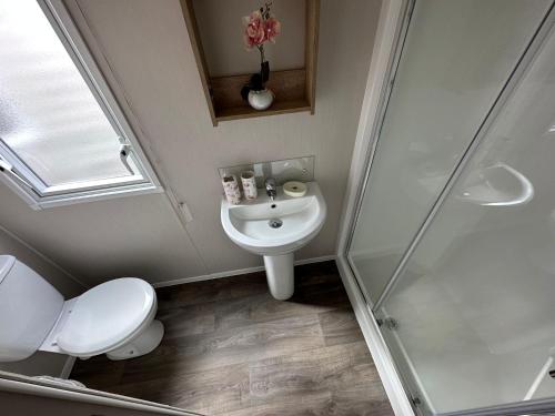 a bathroom with a toilet and a sink and a shower at Heaven Home in Chichester