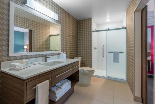 a bathroom with a sink and a toilet and a mirror at Home2 Suites By Hilton Pocatello, Id in Pocatello