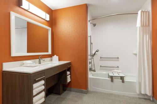 uma casa de banho com um lavatório, uma banheira e um espelho. em Home2 Suites By Hilton Vicksburg, Ms em Vicksburg