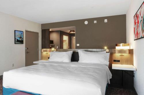 a bedroom with a large white bed and a large mirror at Hilton Garden Inn Bel Air, Md in Bel Air