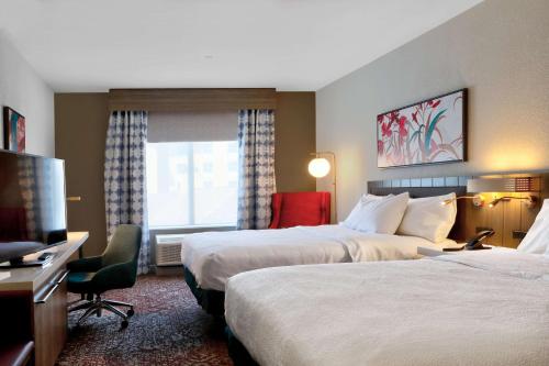 a hotel room with two beds and a television at Hilton Garden Inn Bel Air, Md in Bel Air