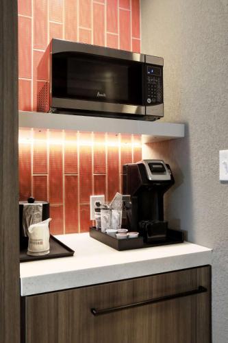 a kitchen with a microwave and a coffee maker at Hilton Garden Inn Bel Air, Md in Bel Air