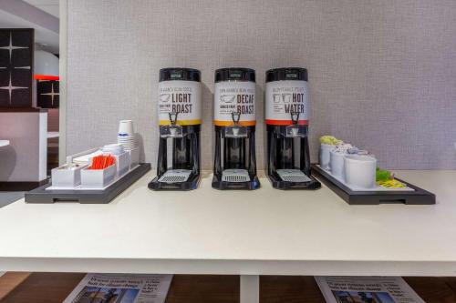 a shelf with four bottles of wine on a table at Hampton Inn & Suites Bloomfield Hills Detroit in Bloomfield Hills