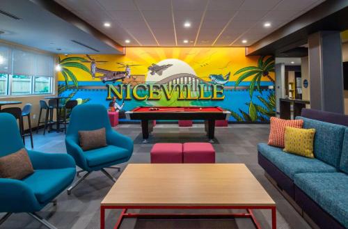 a lobby with a pool table and a nitschula mural at Tru By Hilton Niceville, Fl in Niceville