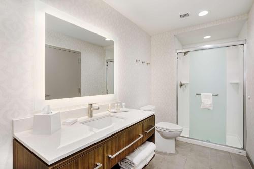 a bathroom with a sink and a toilet and a mirror at Home2 Suites By Hilton Johnson City, Tn in Johnson City