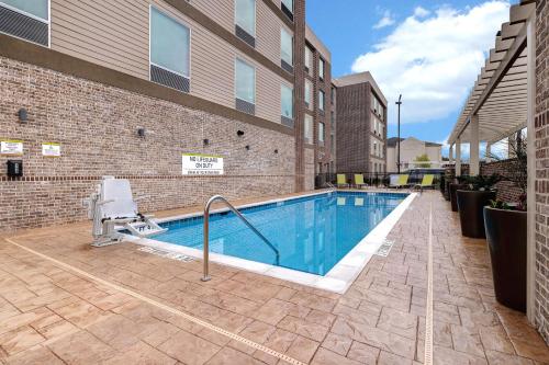 a swimming pool in front of a building at Home2 Suites By Hilton Blythewood, Sc in Blythewood
