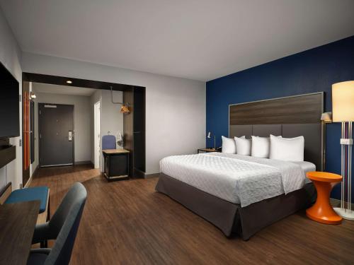 a hotel room with a bed and a table and chairs at Tru By Hilton Tupelo, Ms in Tupelo