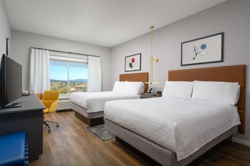 a hotel room with two beds and a television at Hampton Inn & Suites Huntsville Downtown, Al in Huntsville