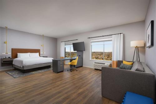 a bedroom with a bed and a desk and a couch at Hampton Inn & Suites Huntsville Downtown, Al in Huntsville