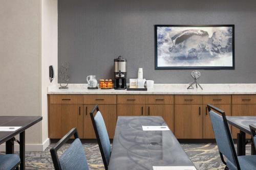 a dining room with a table and a kitchen at Hampton Inn & Suites Huntsville Downtown, Al in Huntsville