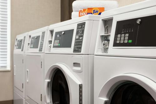 a row of washing machines sitting next to each other at Homewood Suites By Hilton Carlisle in Carlisle