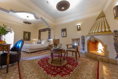 a living room with a bed and a fireplace at Demeures d'Orient Riad & Spa in Marrakesh
