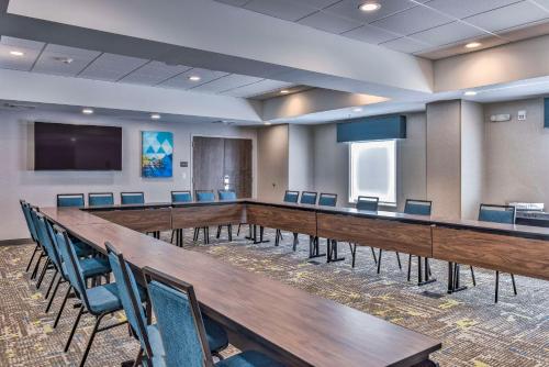 a conference room with a long table and chairs at Hampton Inn & Suites Keene in Keene
