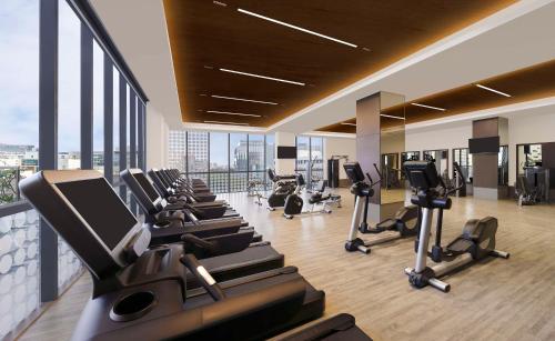 a gym with treadmills and ellipticals in a building at Hilton Bengaluru Embassy Manyata Business Park in Bengaluru