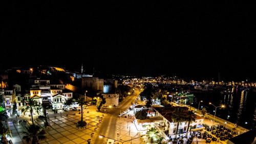a view of a city at night with lights at Rıdvan Hotel in Cesme