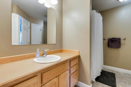 a bathroom with a sink and a mirror at Accommodating Anchorage Abode Less Than 1 Mi to Jewel Lake in Anchorage