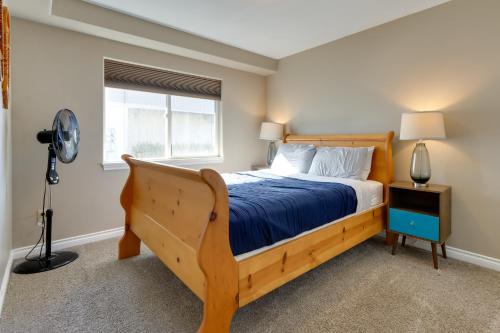 a bedroom with a wooden bed and a window at Accommodating Anchorage Abode Less Than 1 Mi to Jewel Lake in Anchorage