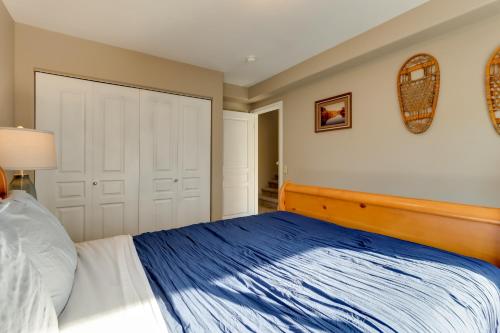 a bedroom with a blue and white bed and a closet at Accommodating Anchorage Abode Less Than 1 Mi to Jewel Lake in Anchorage