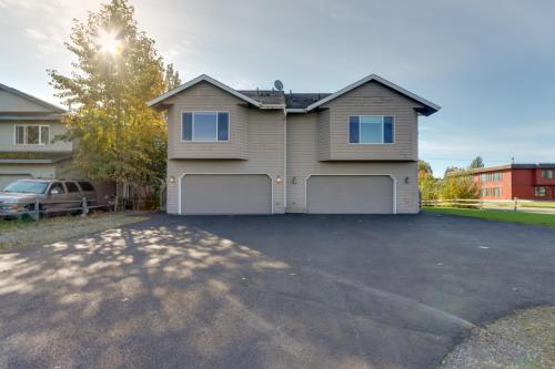 a house with a car parked in a driveway at Accommodating Anchorage Abode Less Than 1 Mi to Jewel Lake in Anchorage