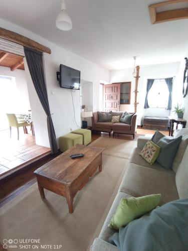 a living room with a couch and a coffee table at A Casa da Bicicleta in Lousã