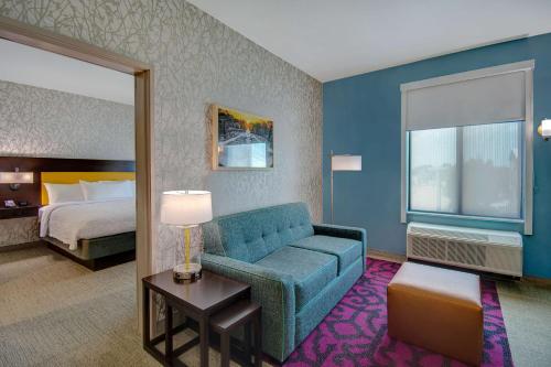 a hotel room with a couch and a bed at Home2 Suites By Hilton Burleson in Burleson