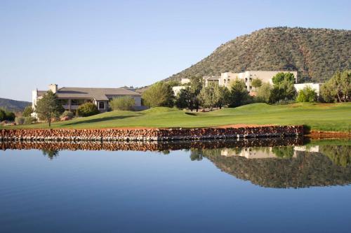 a view of a golf course with a reflection in the water at Hilton Vacation Club Ridge on Sedona in Sedona