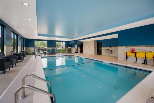 a large pool with blue water in a building at Hampton Inn by Hilton Detroit Southfield in Southfield