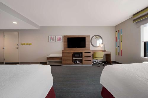 a hotel room with two beds and a television at Hampton Inn by Hilton Detroit Southfield in Southfield