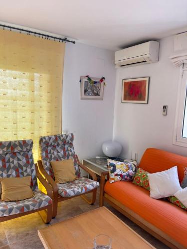 a living room with two chairs and a couch at Cunit Beach in Cunit