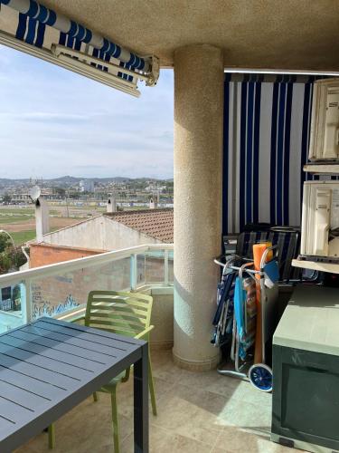 a balcony with a table and chairs and a view at Cunit Beach in Cunit
