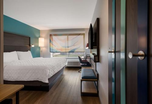a hotel room with a bed and a window at Tru By Hilton Novi Detroit in Novi