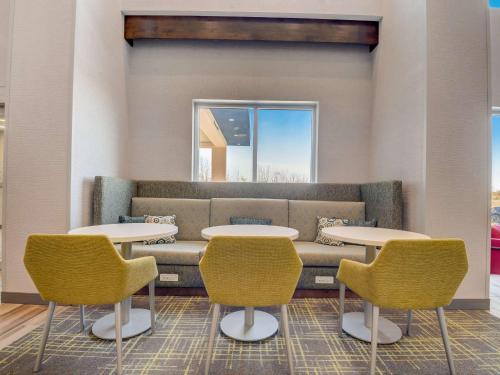a waiting room with two tables and a couch at Hampton Inn & Suites Williamstown Ark Encounter, Ky in Williamstown