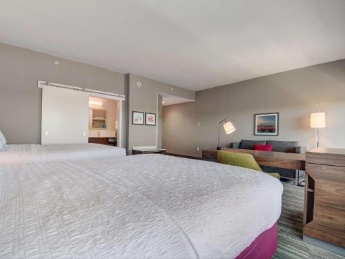 a hotel room with a large bed and a couch at Hampton Inn & Suites Williamstown Ark Encounter, Ky in Williamstown